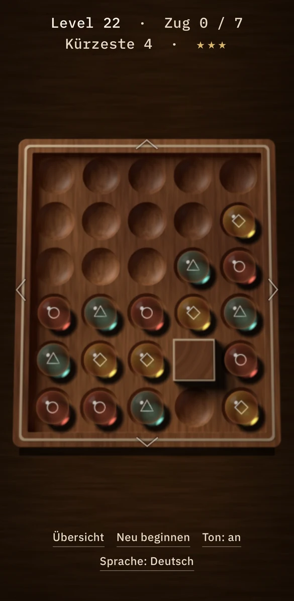 Quiet Gravity, level 22: glass marbles on the walnut board with a solid wall at the lower right.