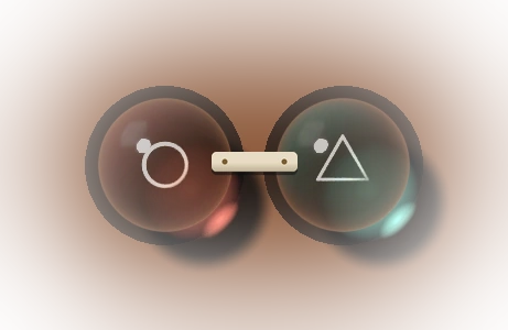 Two marbles joined by a pale bone band with two brass rivets.